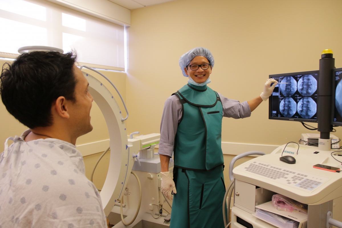 Rehab doctor explaining x-ray images to patient