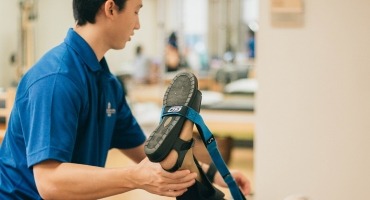 Rehab staff member helping orthopedic rehabilitation patient